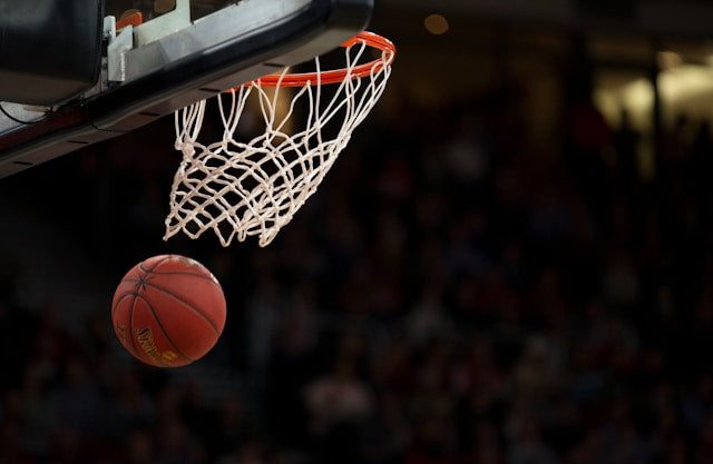 a ball flying through a basketball hoop