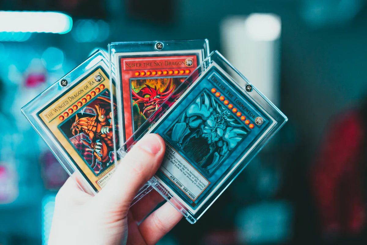 a person holding yu-gi-oh trading cards