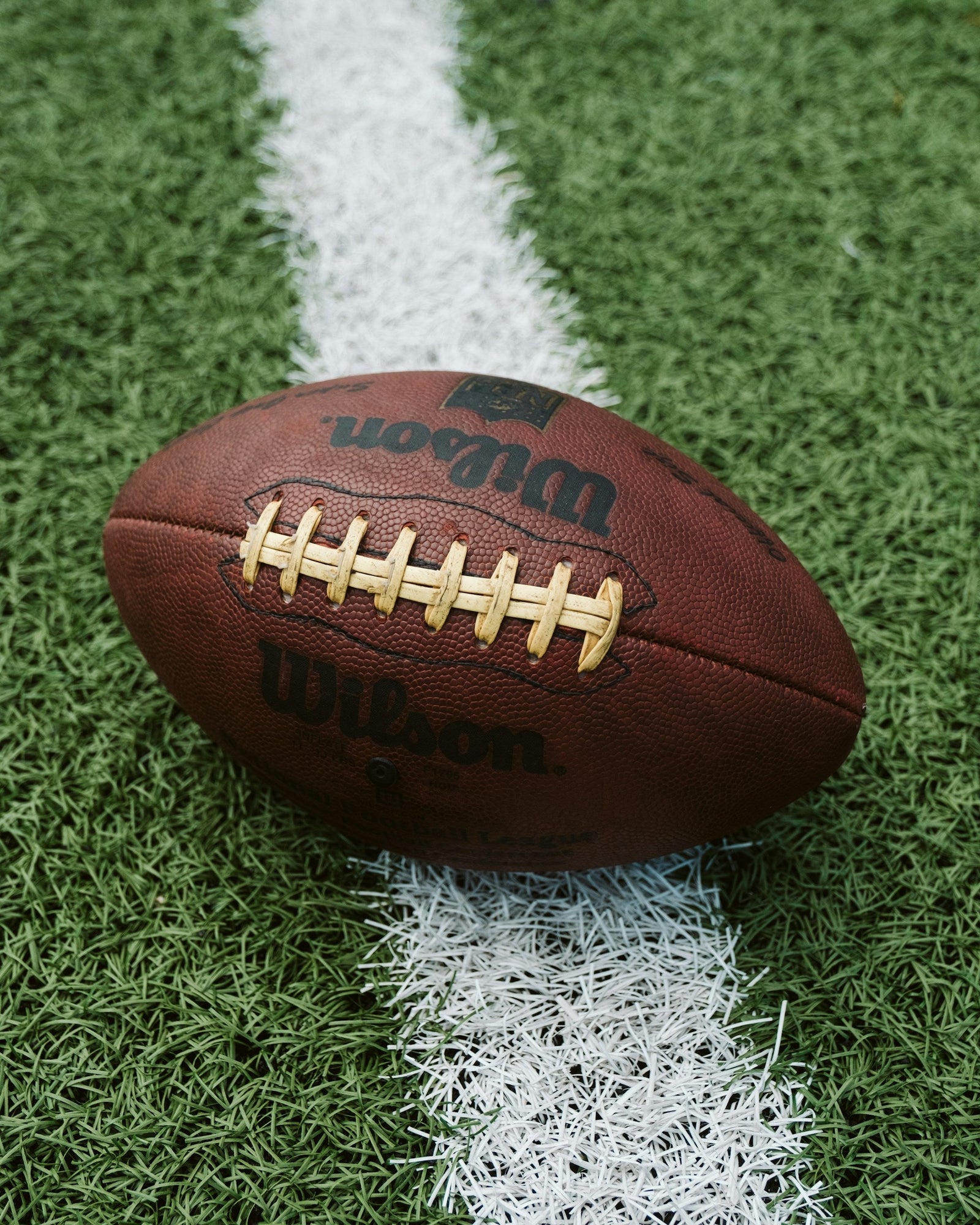 An American football on grass field ahead of the NFL season