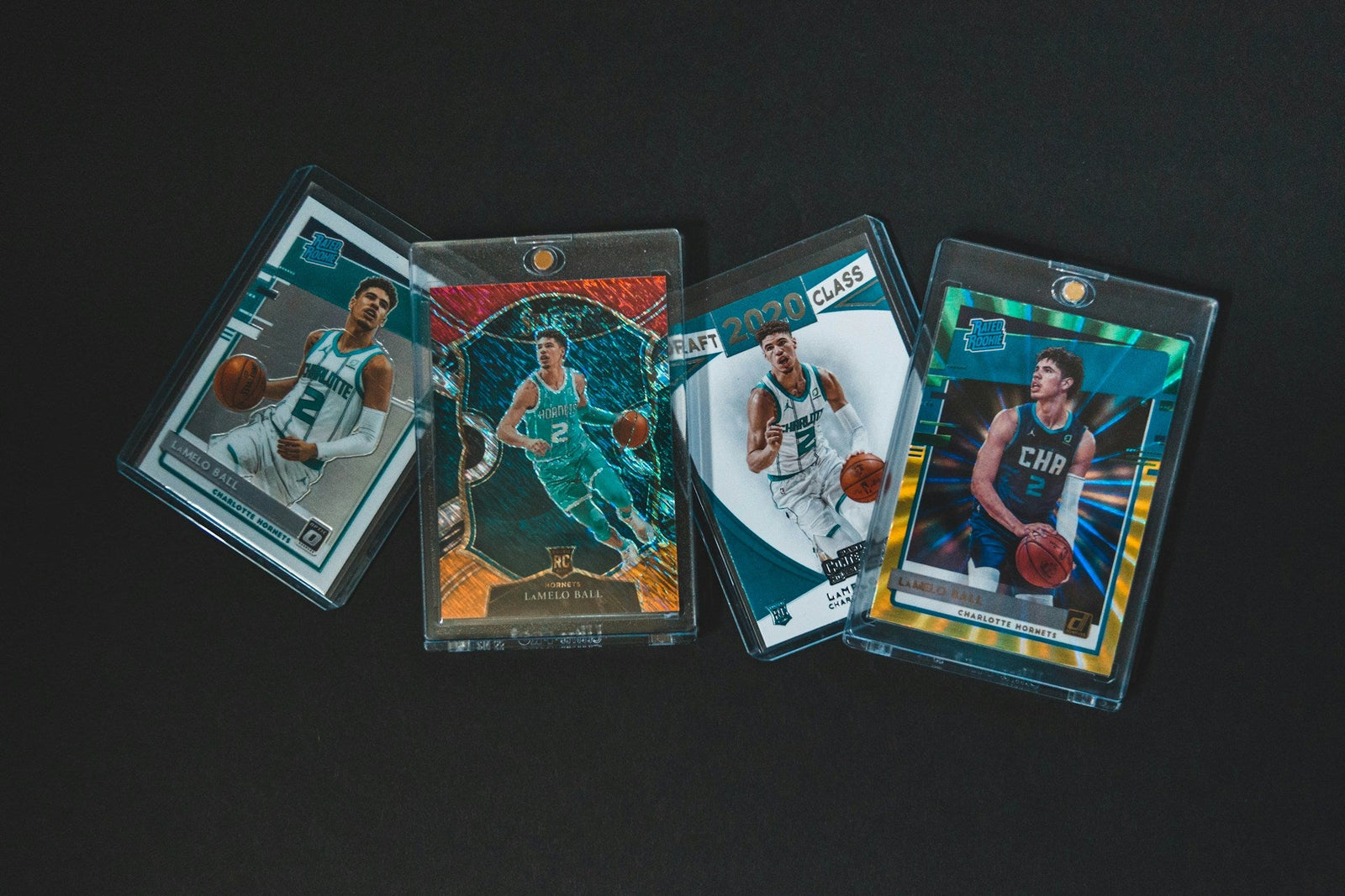 Four basketball cards in sleeves