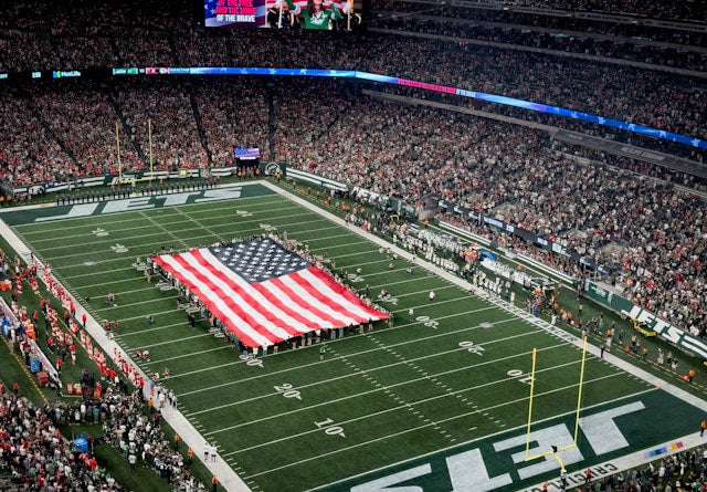 Packed football stadium with a flag in the middle