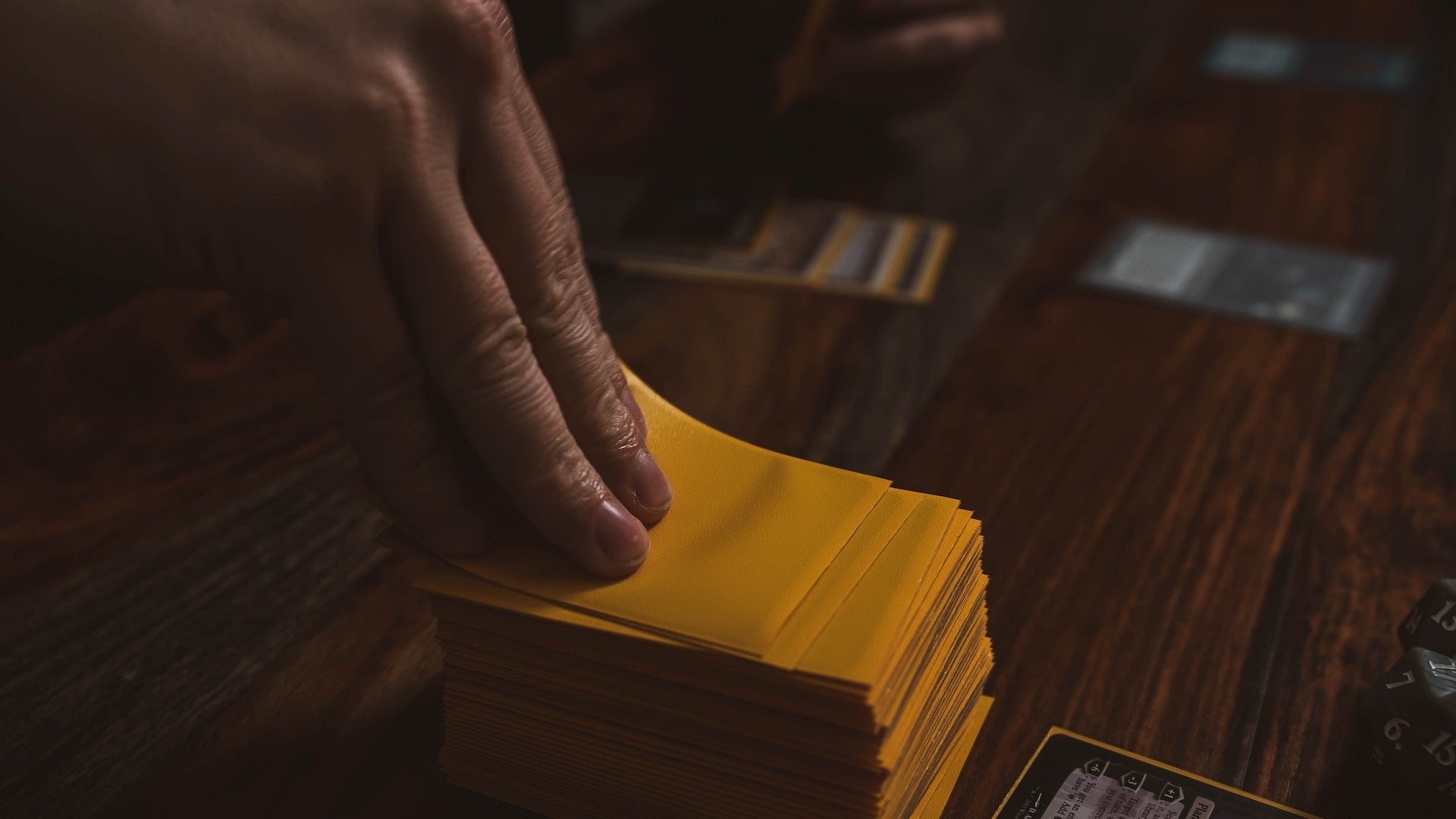 a person pulling a card from a yellow stack