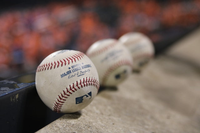 three baseballs on the ground